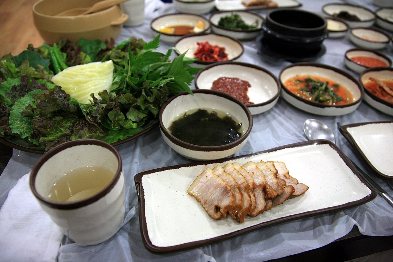 南海で提供された、葉野菜を添えた豚肉の食卓。