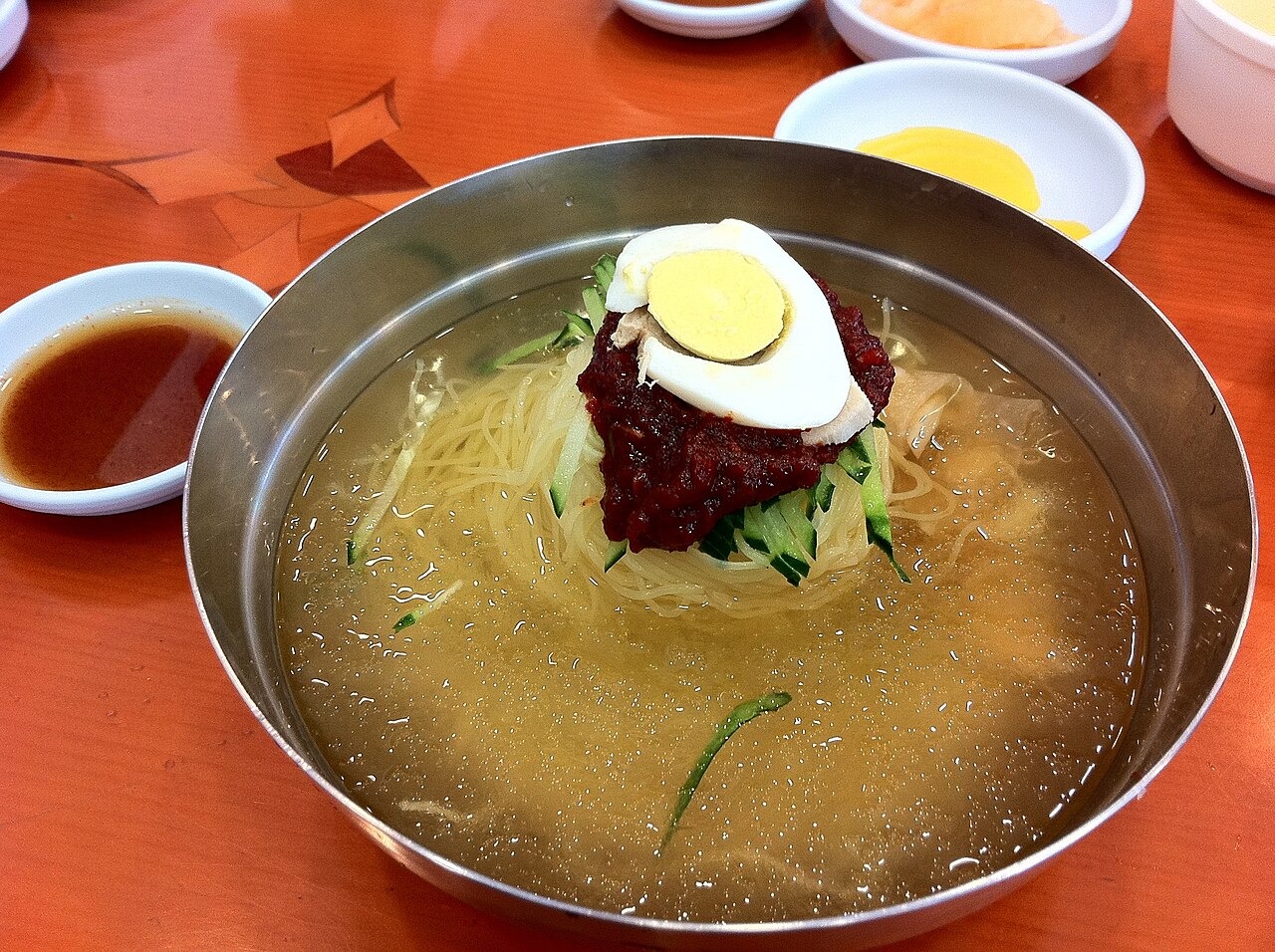 透明感のある汁と赤い薬味のミルミョン。