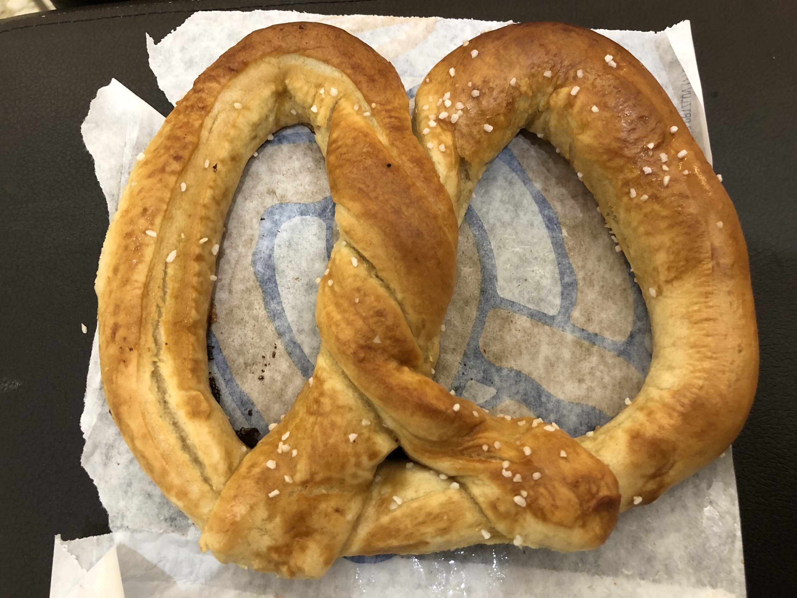 Auntie Anne's の塩をふったソフト・プレッツェル（紙の上）